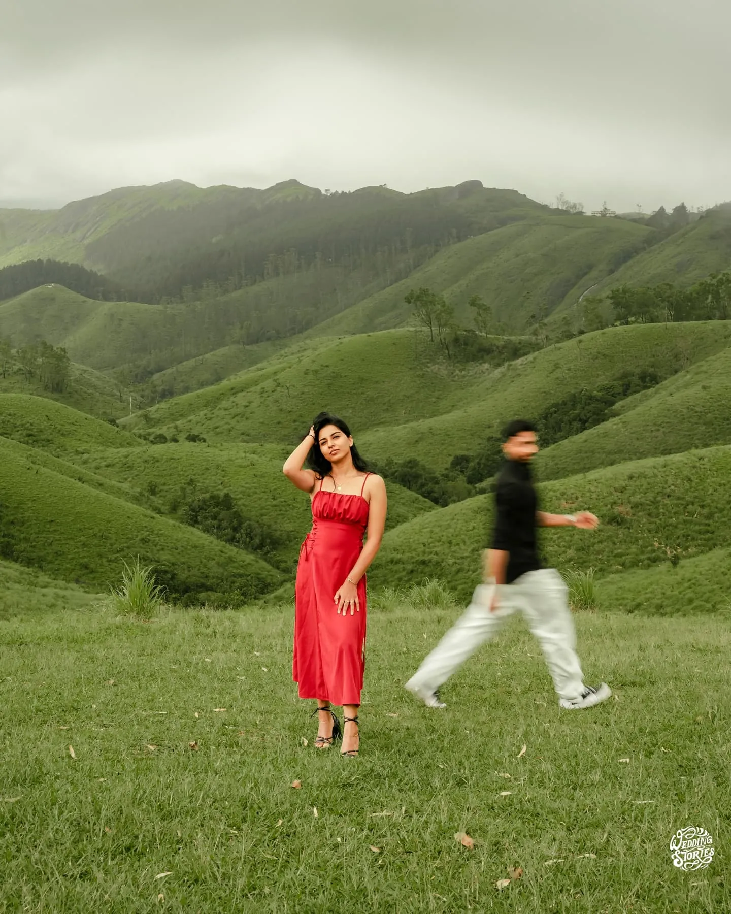 A couple walking together through rolling green hills